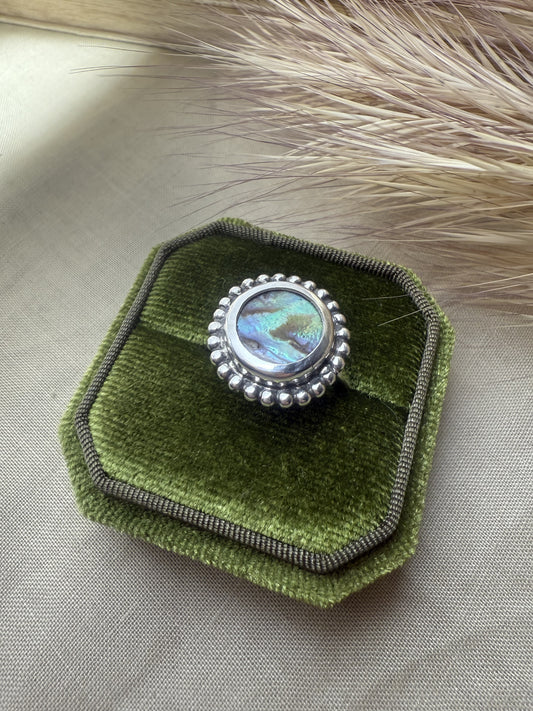 Artisan abalone ring in oxidized sterling silver showing natural ocean colors.