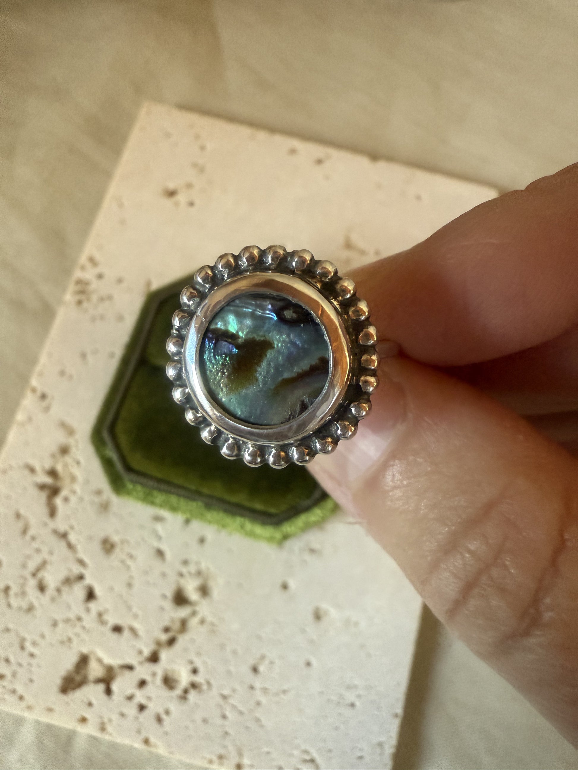 Boho-style sterling silver abalone shell ring with oxidized detailing.